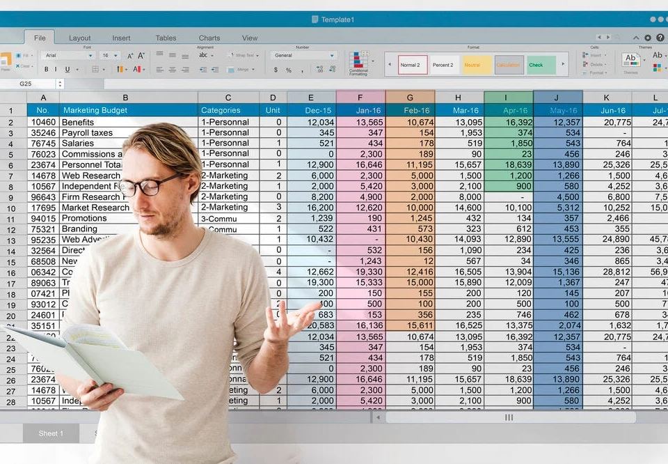 Man in glasses analyzing a spreadsheet with digital marketing KPIs like 'Marketing Budget' and 'Web Research' expenses.