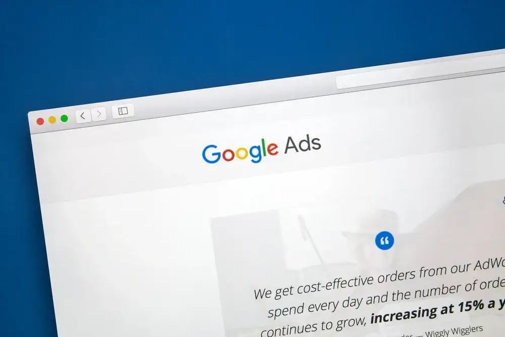 A magnifying glass hovering over a bar chart and Google Ads interface, showing 5 proven ways to improve Google Ads Quality Score