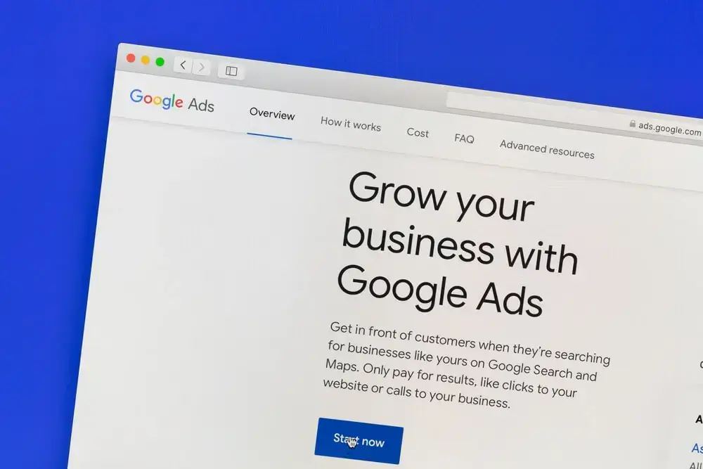 A person's hands holding a tablet displaying Google Ads reports, symbolizing how Google Ads can help advance business goals