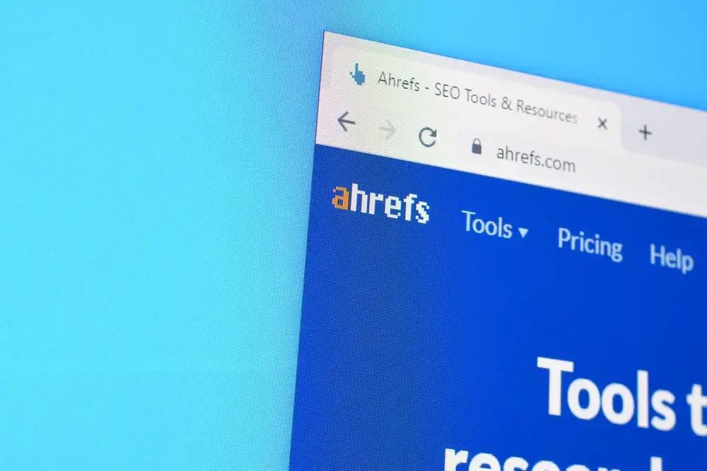 A person at a desk analyzing various colorful charts and graphs on a laptop and tablet, making keyword research easy for a beginner's guide to SEO in 2026
