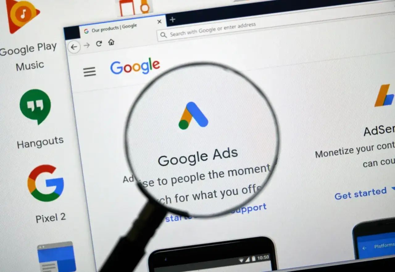 A magnifying glass hovering over various charts and data points, illustrating the critical steps of a Google Ads audit