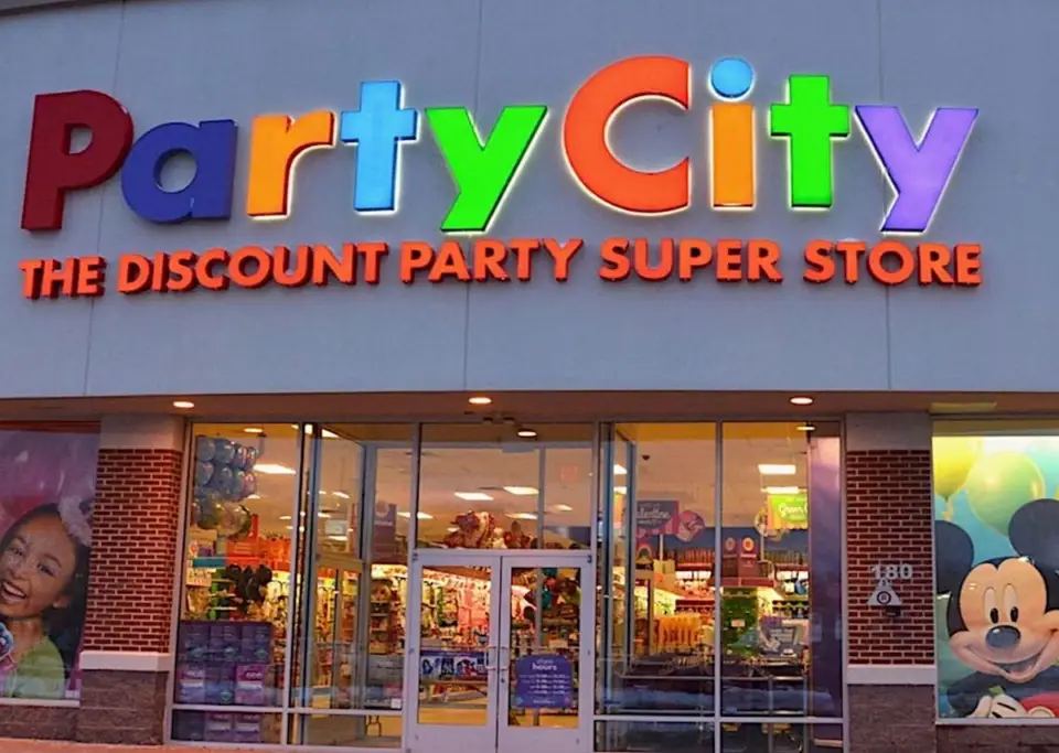 Exterior of a Party City store, a prime example of seasonal marketing with bright signs and window displays.