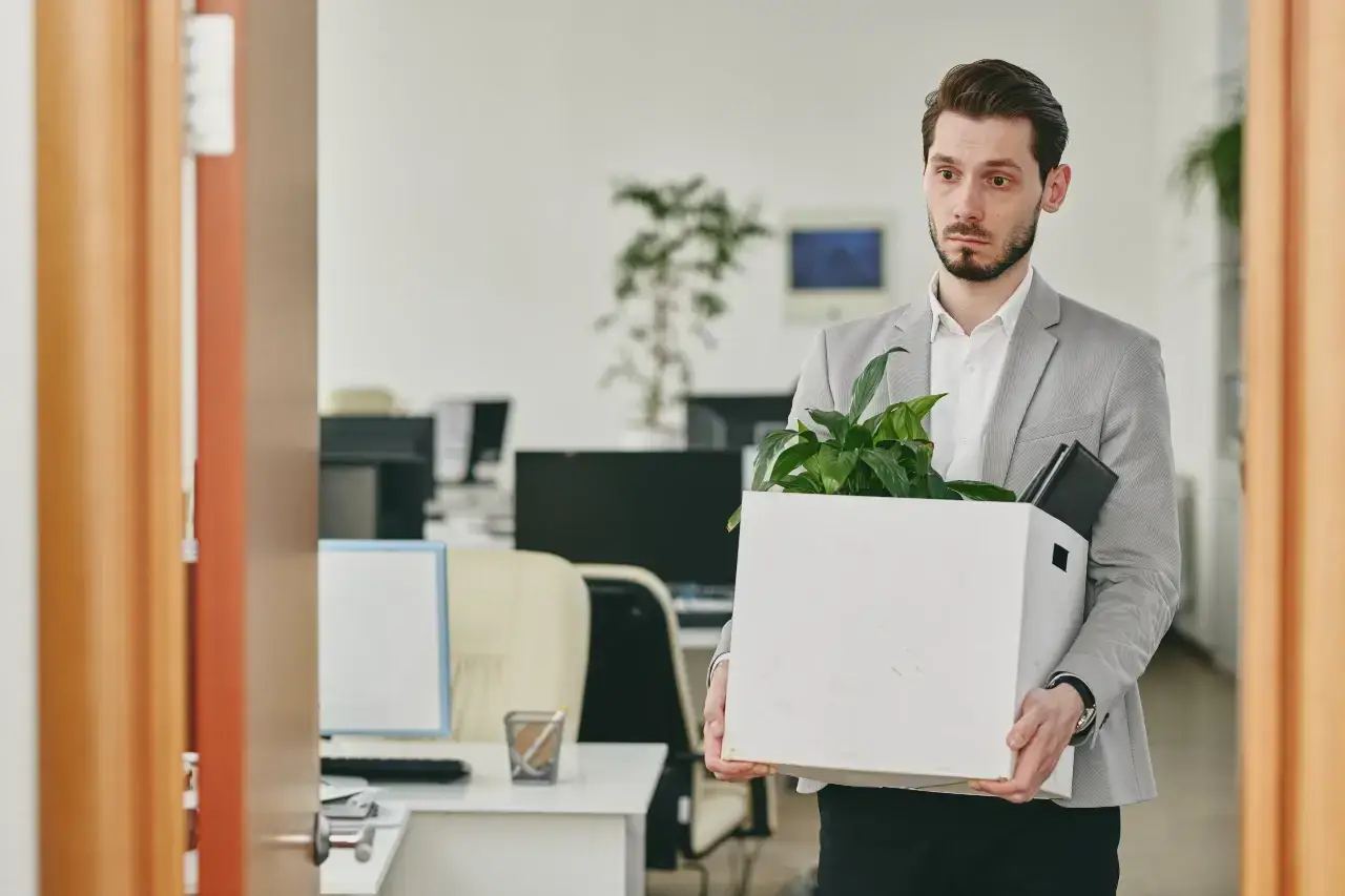 A diverse team of marketing professionals, including a CMO, collaborating in a modern open-plan office, some looking at a tablet