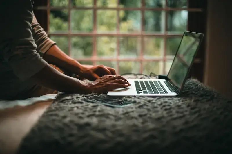 A diverse group of people using laptops and phones, illustrating various ways to drive organic traffic to a website