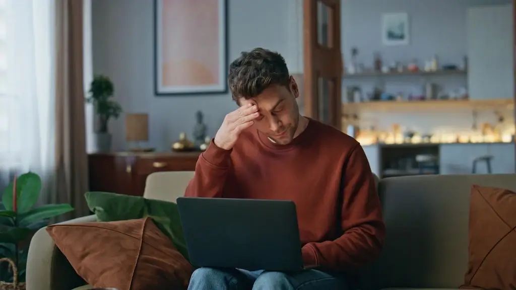 A marketer looking stressed, surrounded by tangled wires, monitors with charts, and a large red "stop" sign to symbolize SEO mistakes